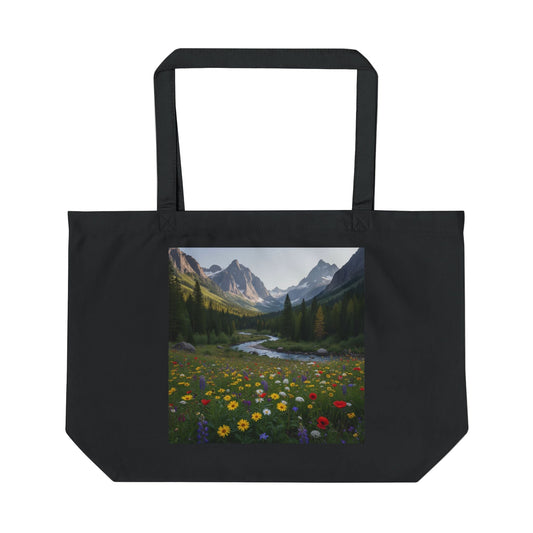 Black tote bag with a scenic print of mountains and flowers on a white background