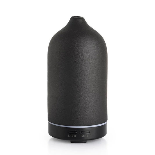Black essential oil diffuser on a white background