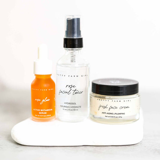 Set of skincare products including a serum, toner, and cream on a white surface.