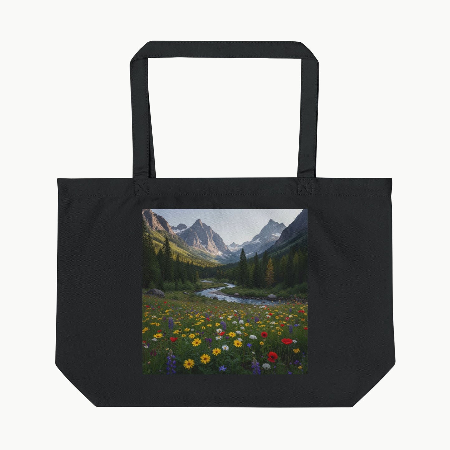 Black tote bag with a scenic print of mountains and flowers on a white background