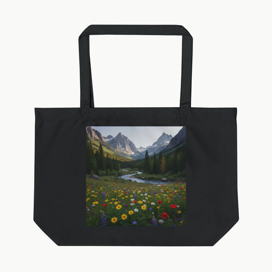Black tote bag with a scenic print of mountains and flowers on a white background