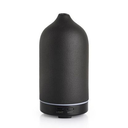 Black essential oil diffuser on a white background