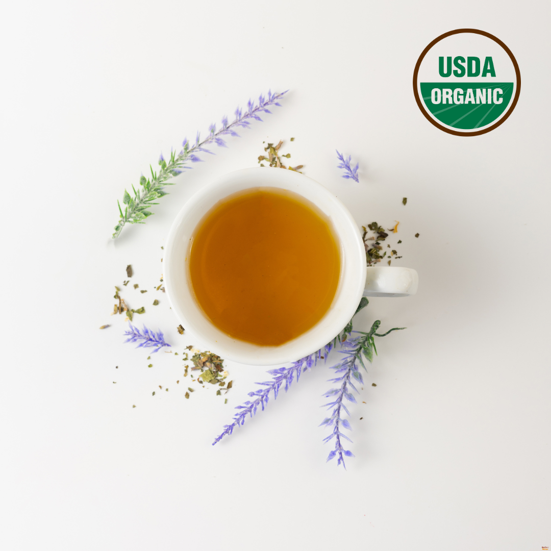 Tea cup with herbs and flowers on a white background, featuring the USDA Organic logo.