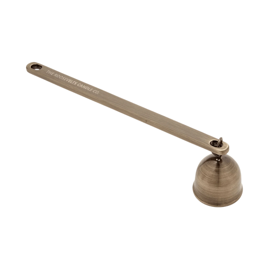 Bronze candle snuffer with 'The Woodwick Candle Co.' branding on a white background