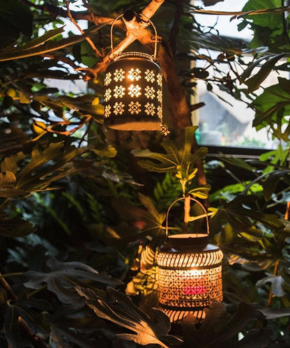 Decorative lanterns hanging among green foliage